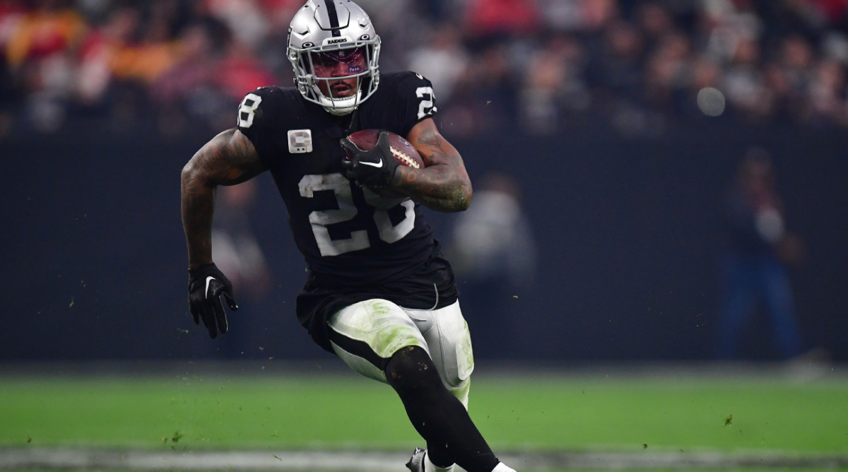Jan 7, 2023; Paradise, Nevada, USA; Las Vegas Raiders running back Josh Jacobs (28) runs the ball against the Kansas City Chiefs during the second half at Allegiant Stadium. Mandatory Credit: Gary A. Vasquez-USA TODAY Sports